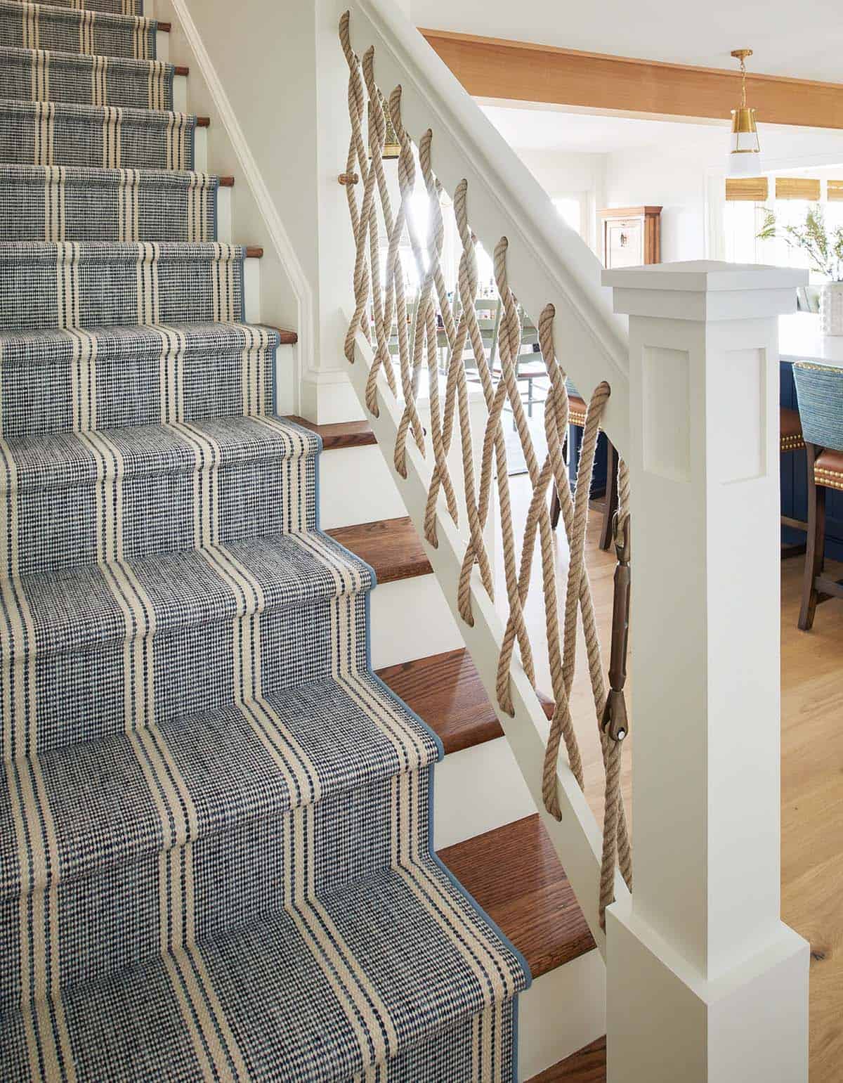 Staircase with striped runner and rope banister detail