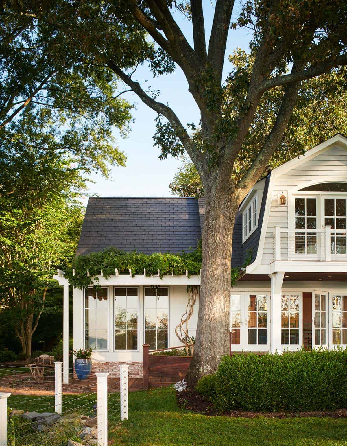 Exterior view of pergola-covered porch and gambrel dormer