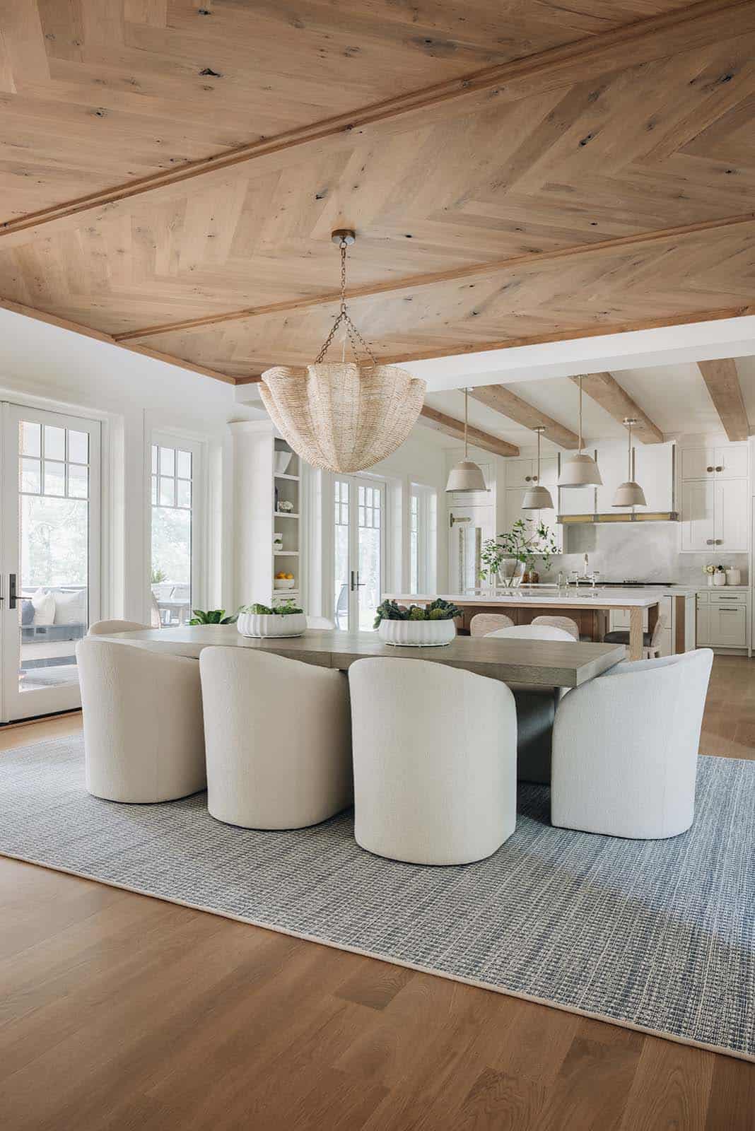 Dining area with herringbone wood ceiling and woven pendant over table
