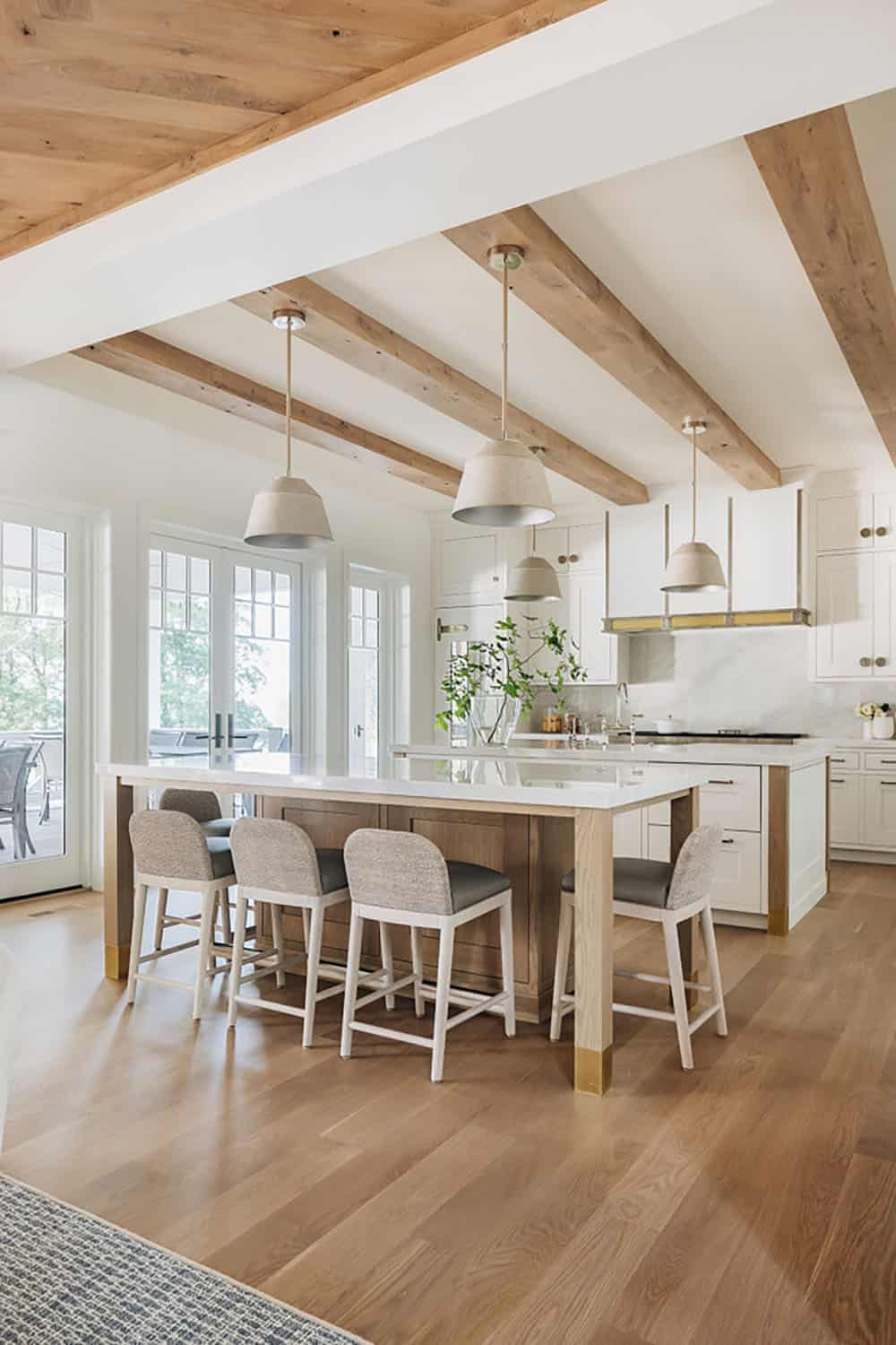 Kitchen with wood beam ceiling, dual islands, and pendant lighting