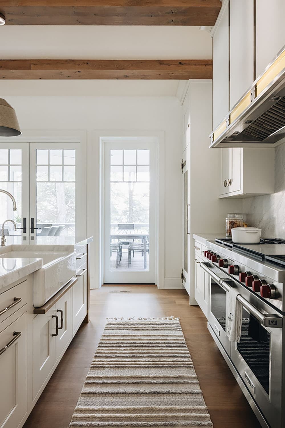 Kitchen view toward screened porch door beside stainless range