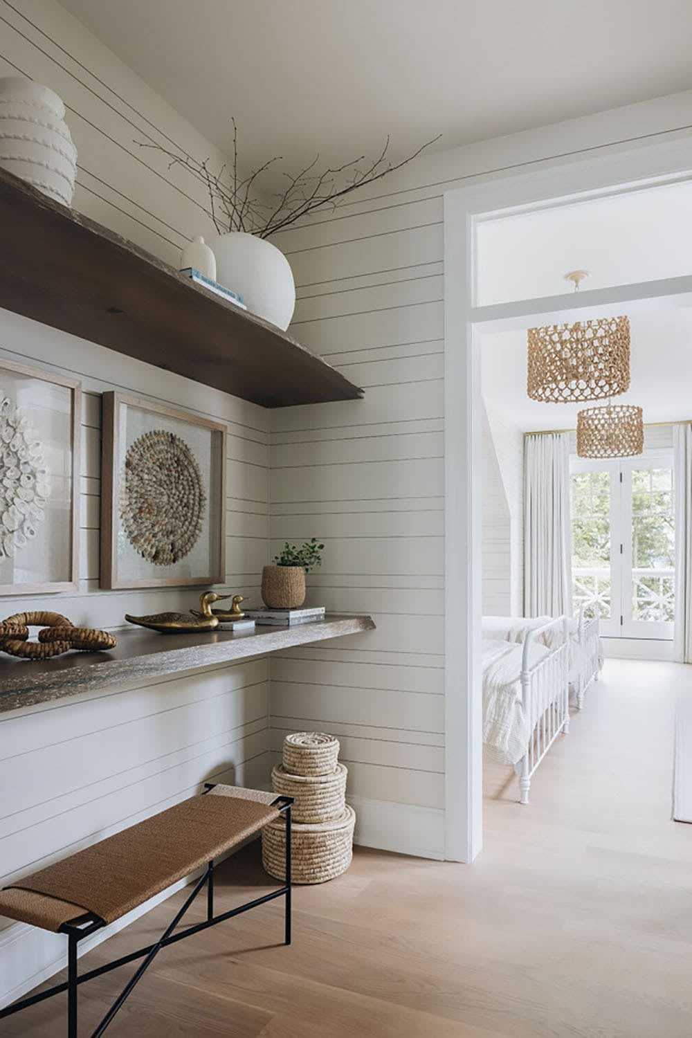 Shiplap hallway nook with shell art, woven baskets, and view to kids' room