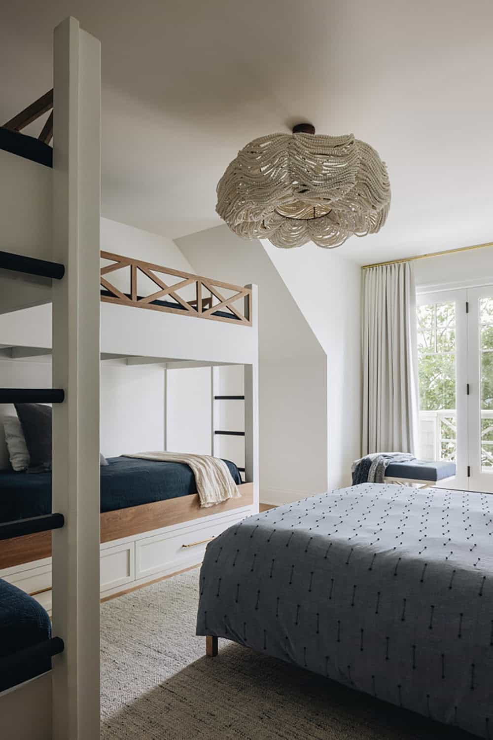 Bedroom with scalloped bead chandelier and built-in bunk beds