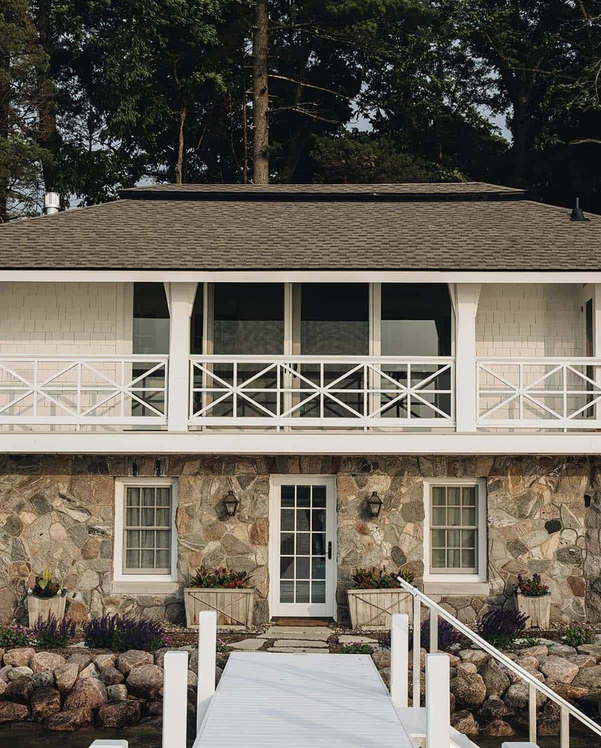 Boat house lakeside facade with stone base and private dock