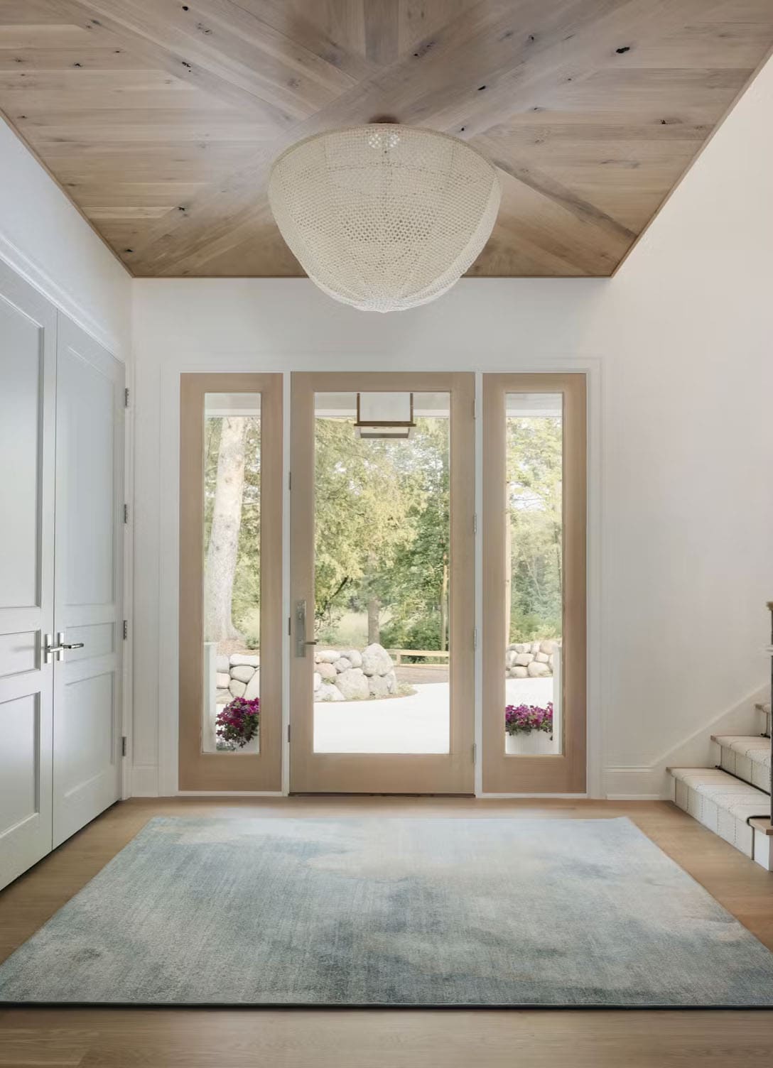 beach style lake house entry with an area rug