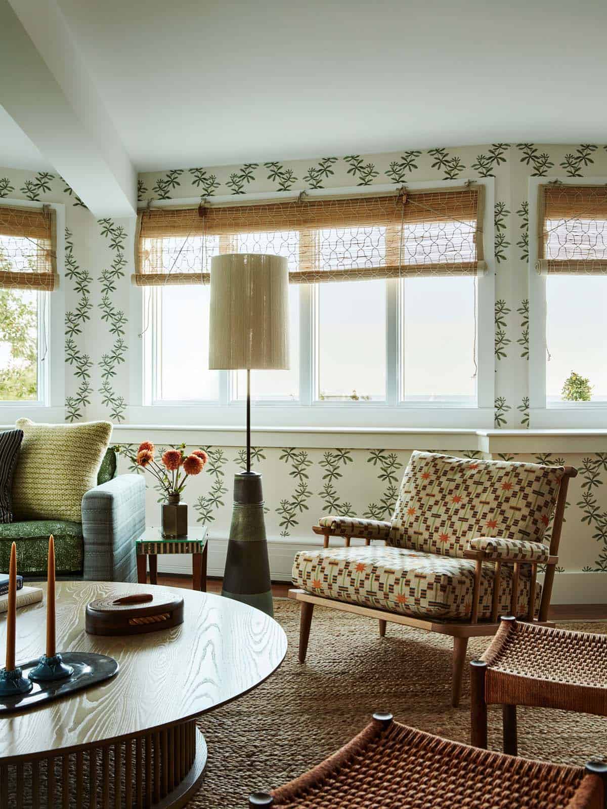 Sitting area with patterned wallpaper and woven jute rug