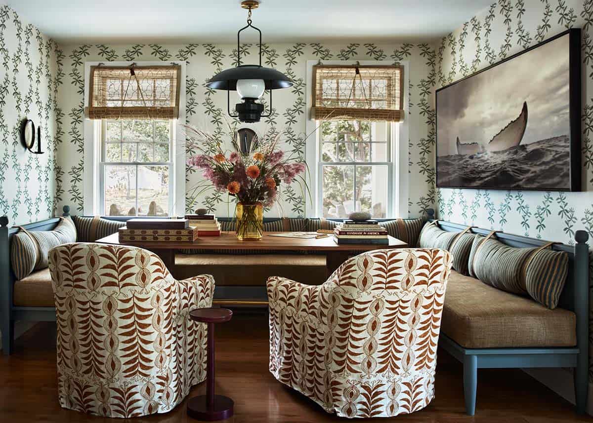 Banquette dining nook with botanical wallpaper and whale photograph