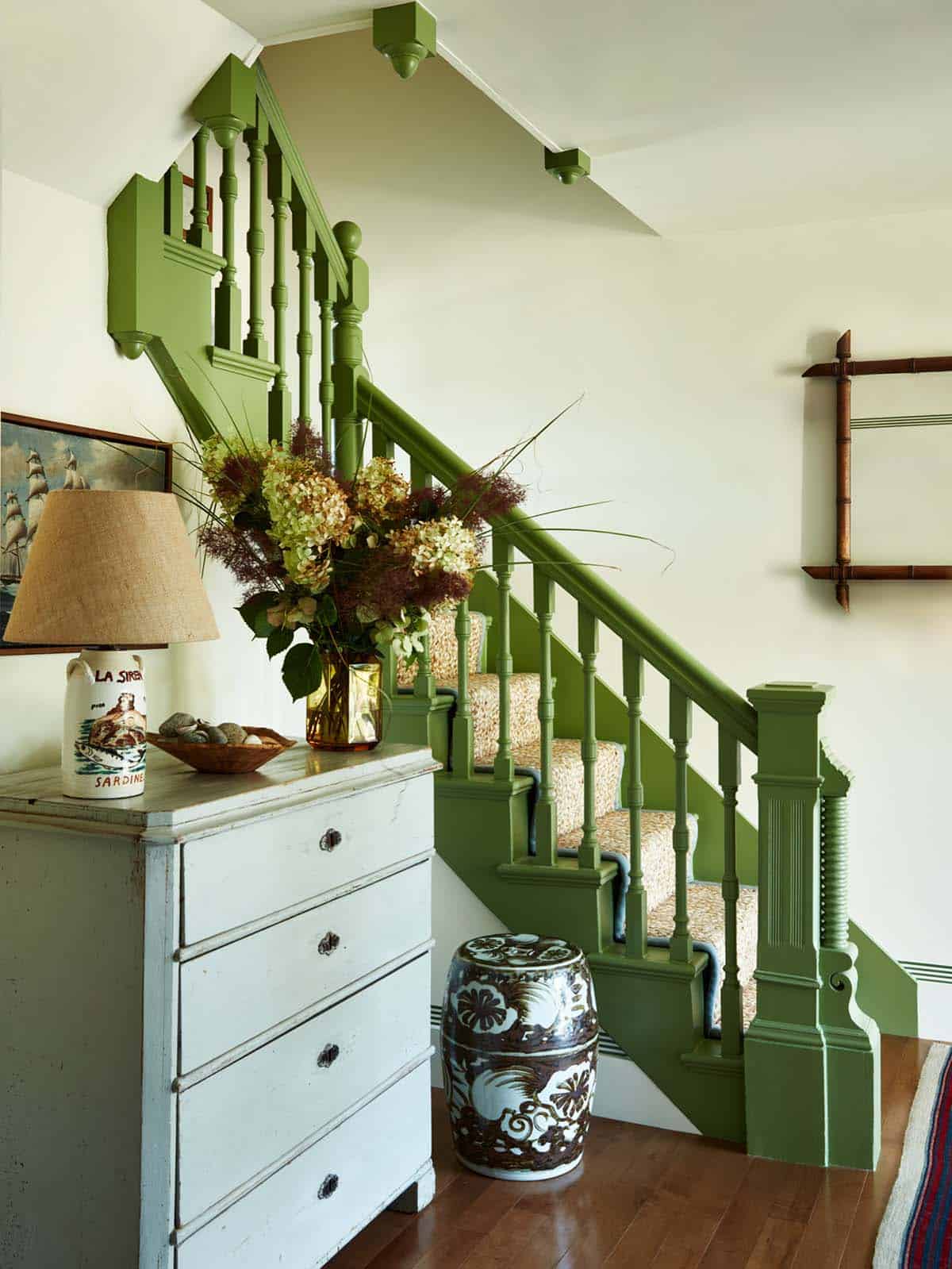 Green staircase detail with dried hydrangea arrangement
