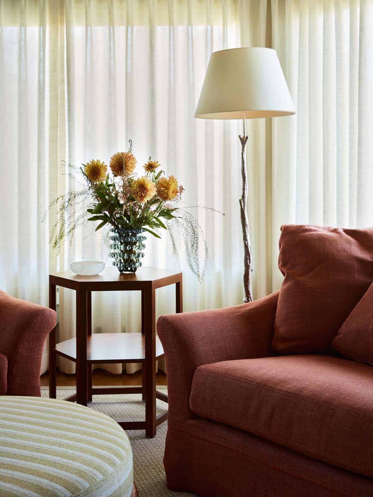 Sitting area detail with dahlia arrangement and floor lamp