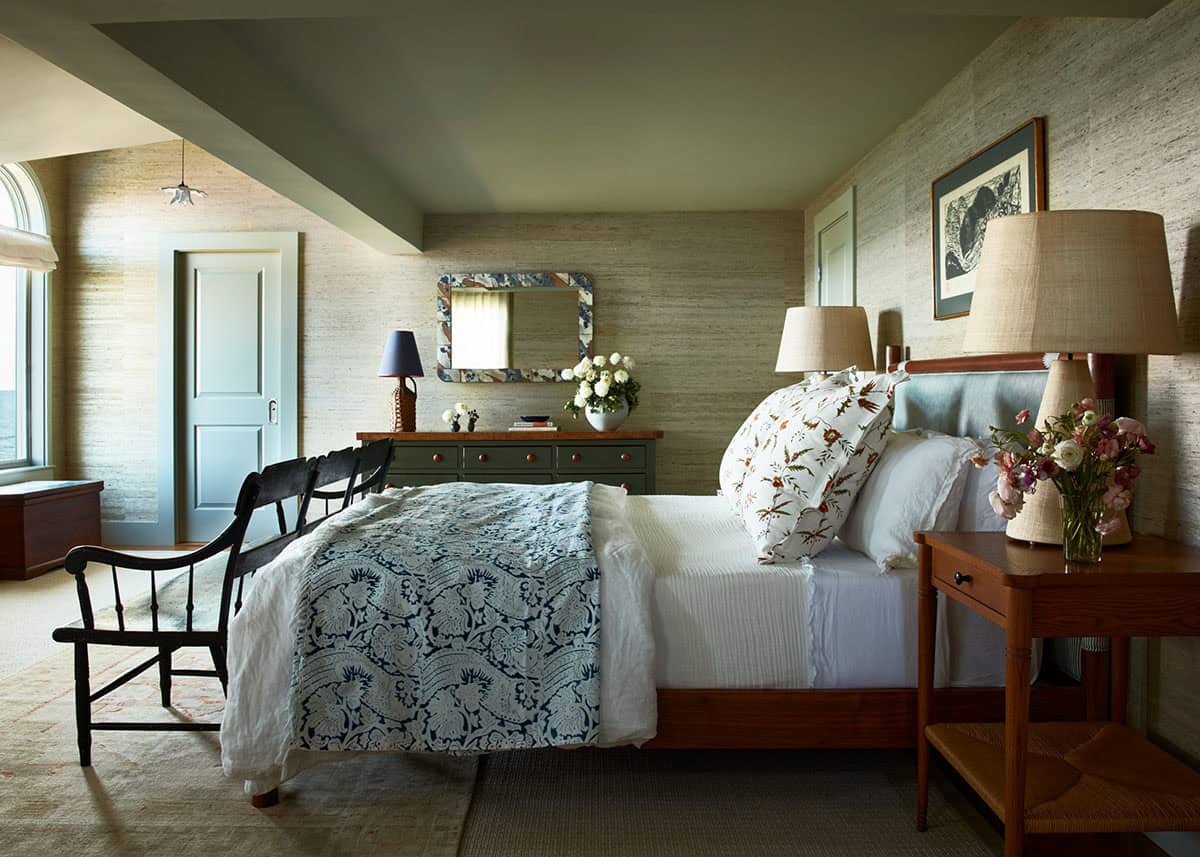 Primary bedroom with grasscloth walls and floral bed linens