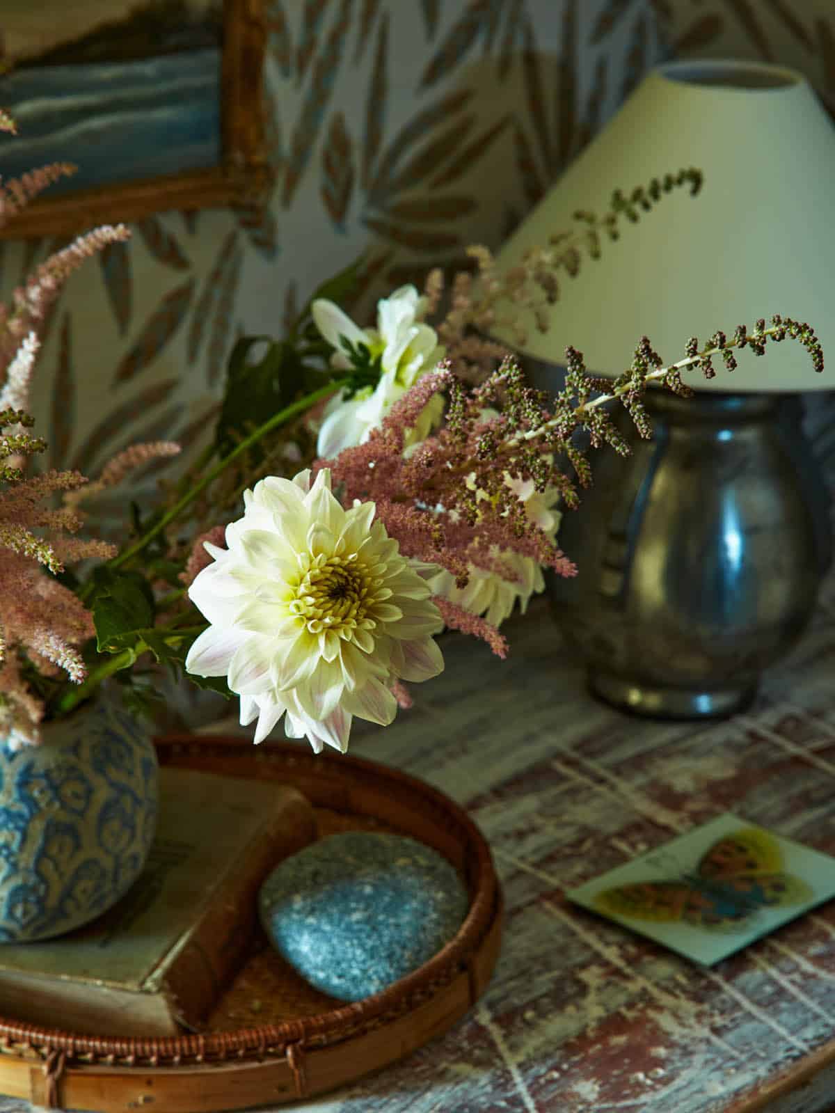 Still life of dahlias and astilbe on patterned tray table