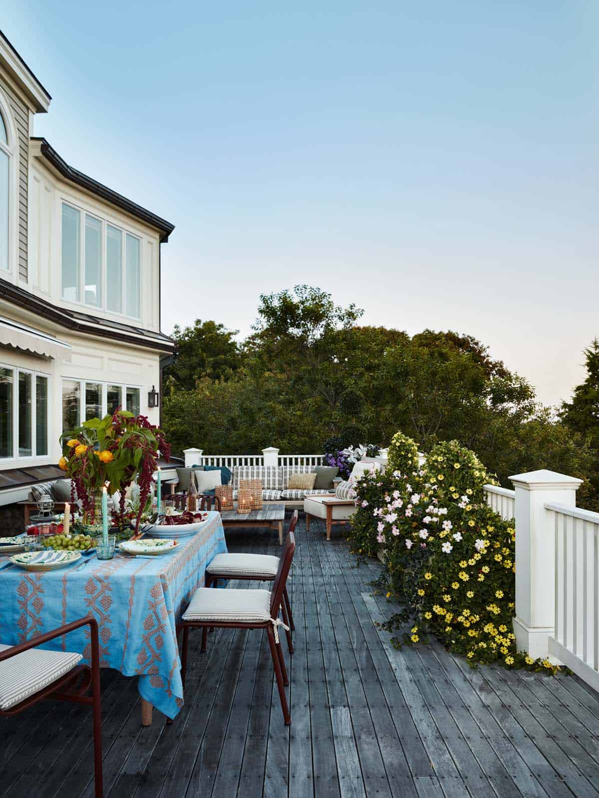 Evening deck with striped tablecloth and floral centerpiece