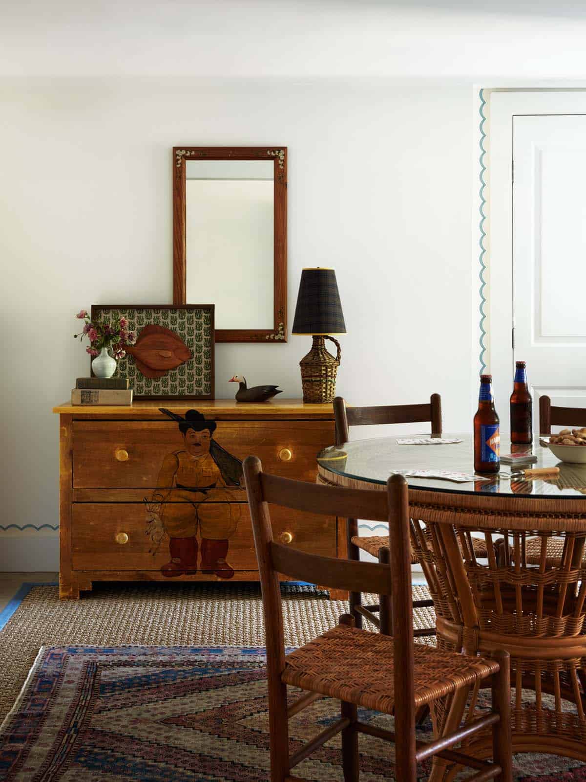 Painted vintage dresser with round dining table and rattan chairs