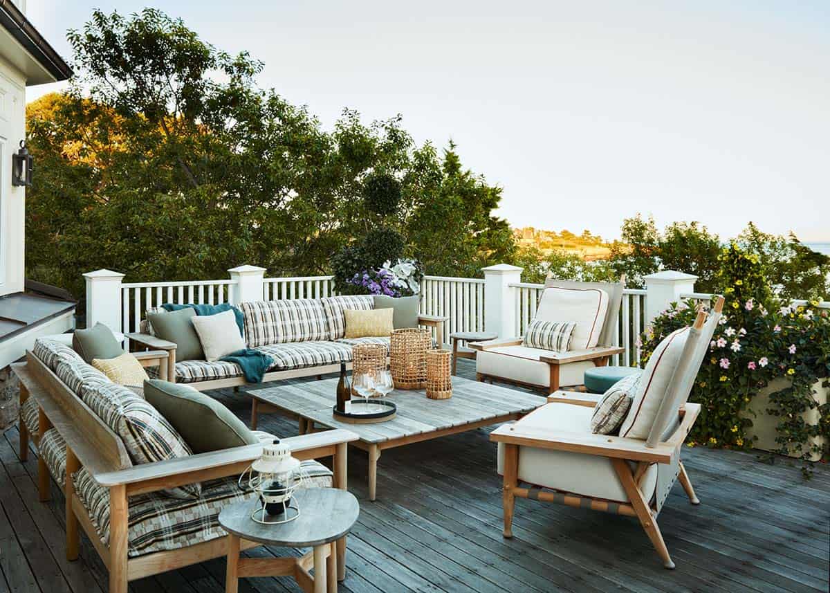 Deck lounge area with striped cushions and sunset ocean view