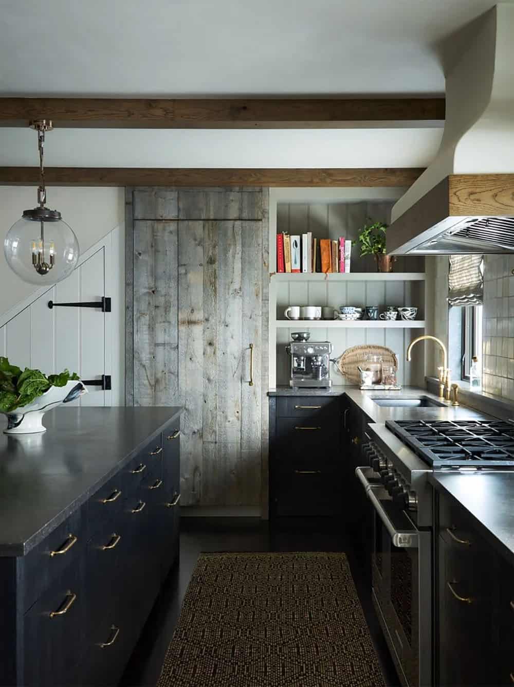 Kitchen island with brass hardware, open shelving, and barn door pantry