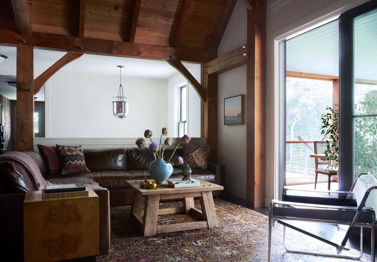 Timber-frame living room with leather sectional and artichoke centerpiece