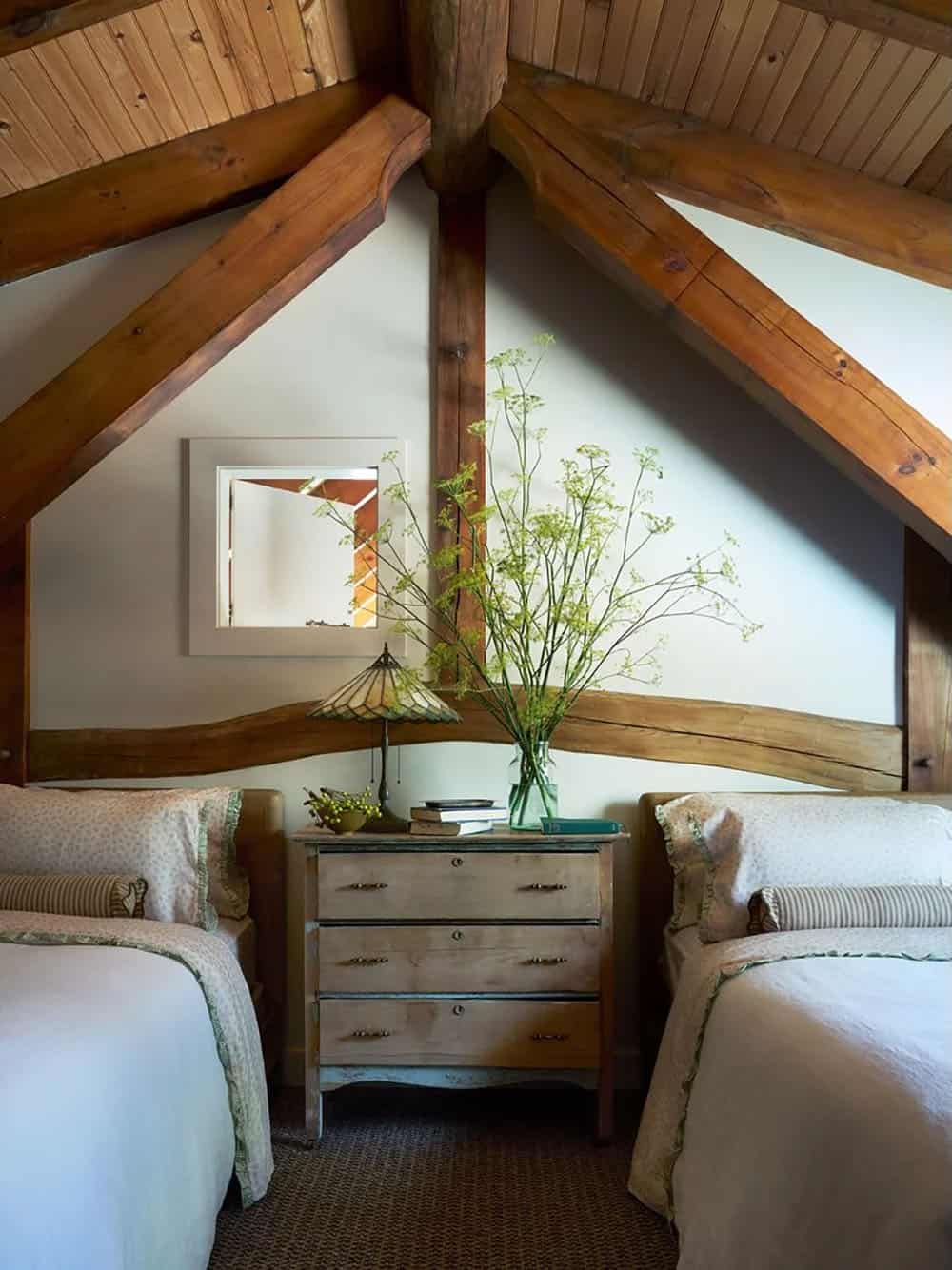 Attic bedroom with exposed timber beams and twin beds