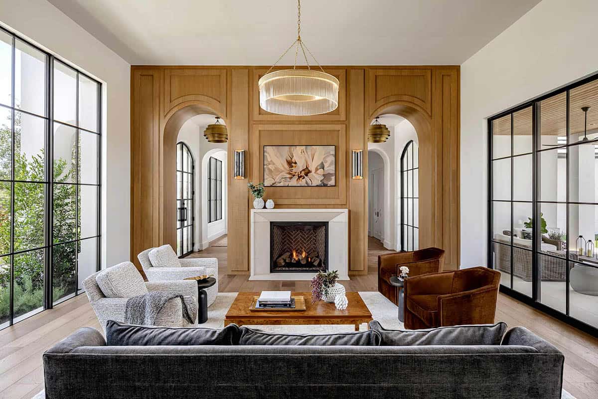 Living room with wood paneled fireplace wall and arched doorways
