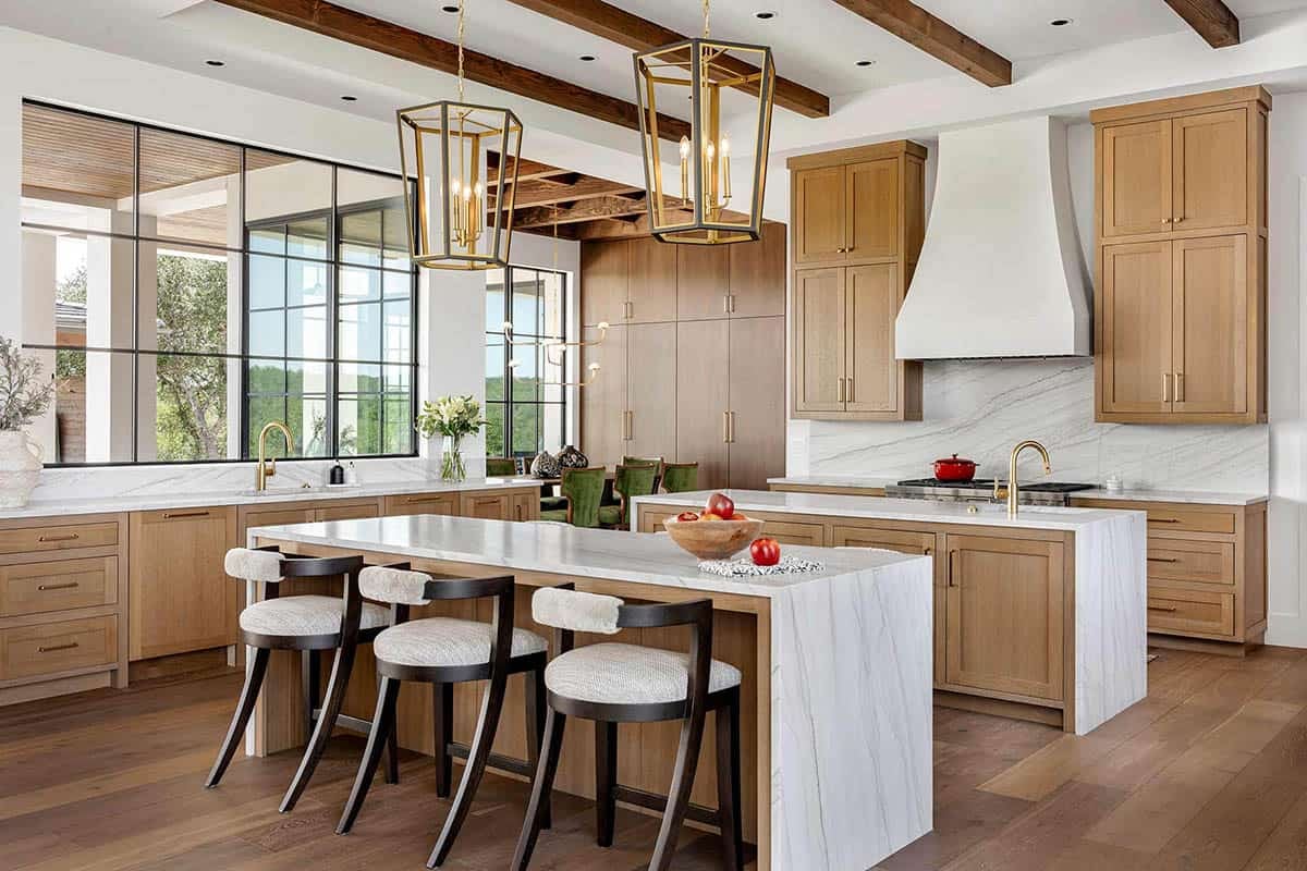Dual island kitchen with wood cabinetry and marble countertops