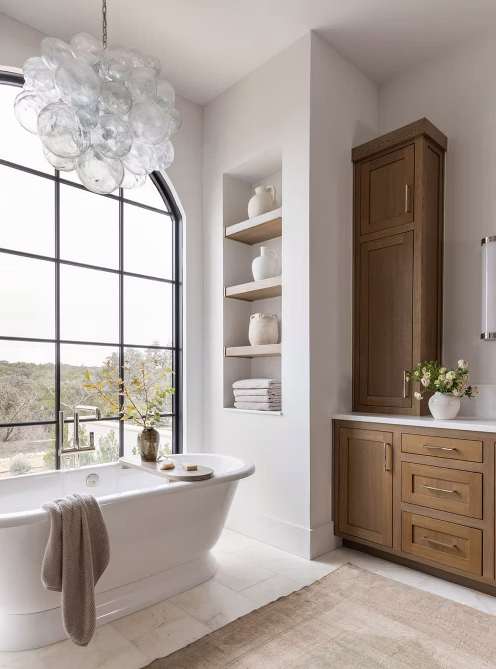 Soaking tub with built-in shelving and wood linen cabinet