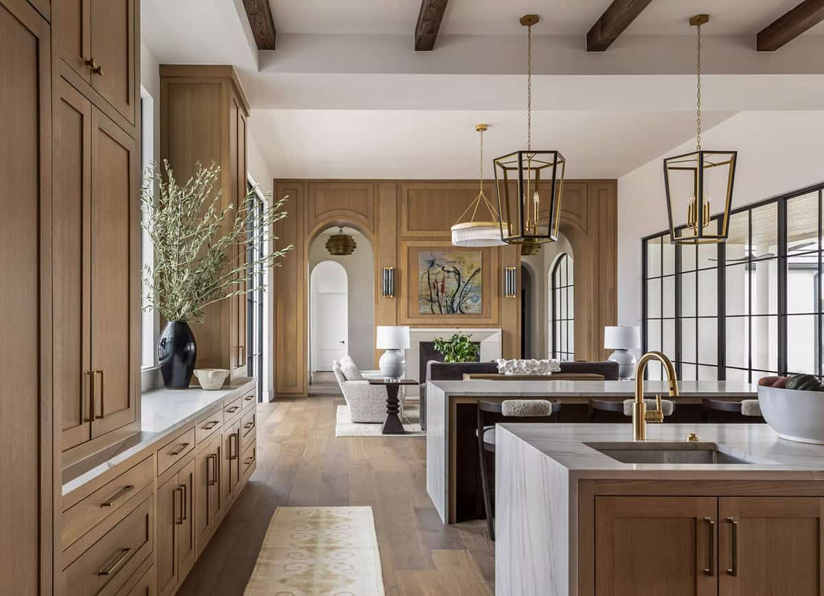 Kitchen island view toward living room with arched wood paneling