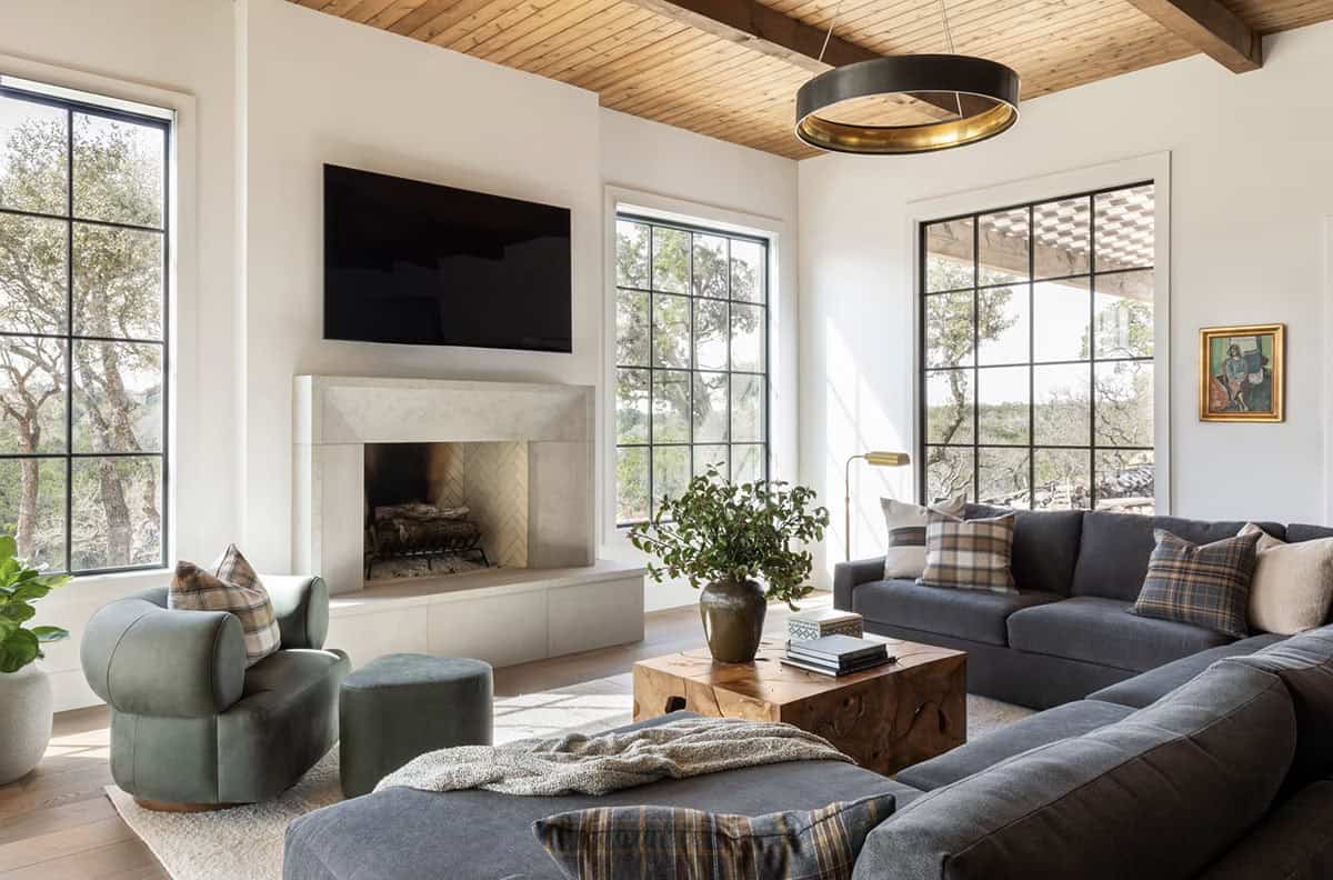 Living room with plaid pillows and steel framed window views