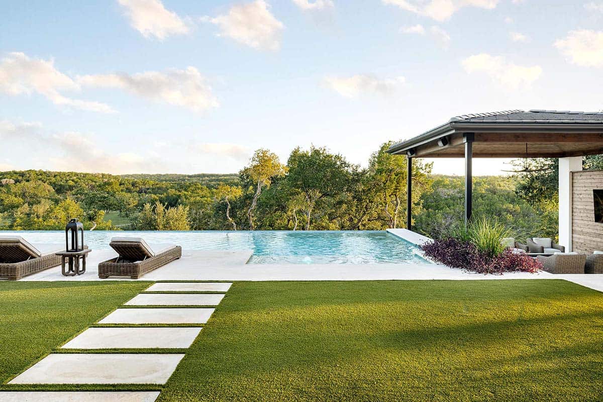 Infinity pool overlooking Texas hill country with covered patio