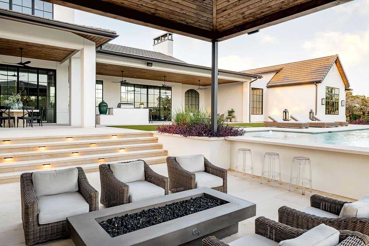 Covered patio with fire pit and steps leading to pool