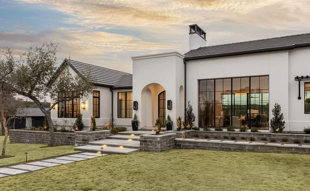 Front exterior at dusk with stone steps and arched entry