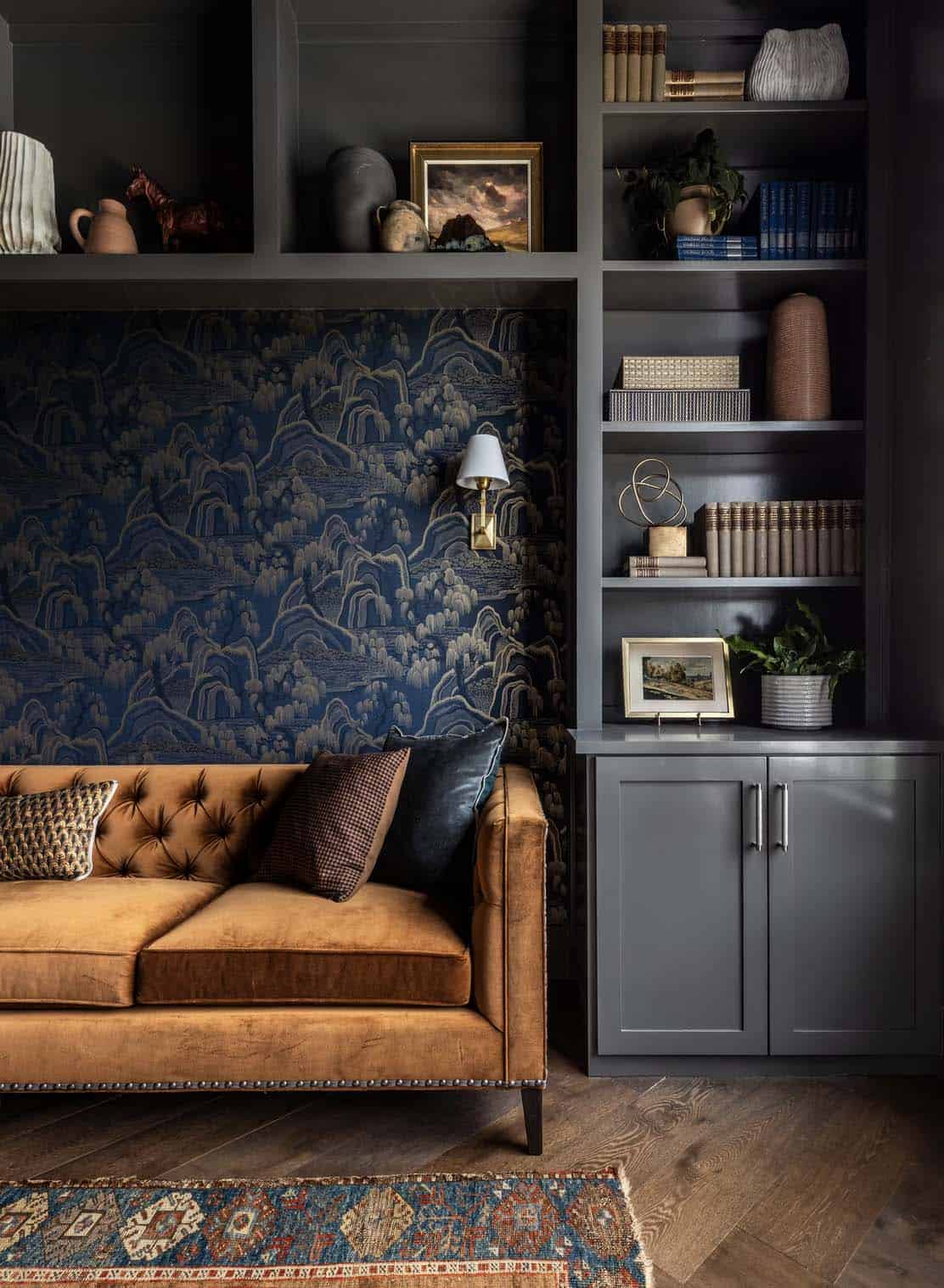 Reading nook in the study with tufted sofa and Chinoiserie mountain wallpaper