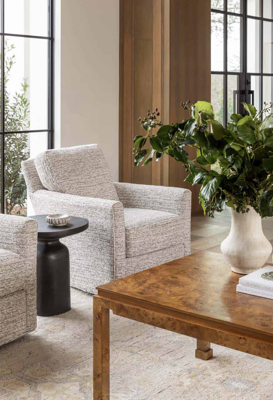 Living room seating area with boucle chairs and burl wood table