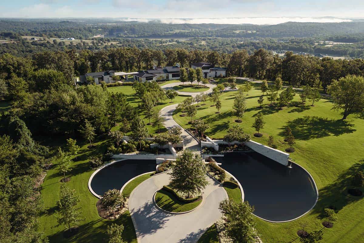 Aerial view of black reflecting pools framing a stone driveway entrance