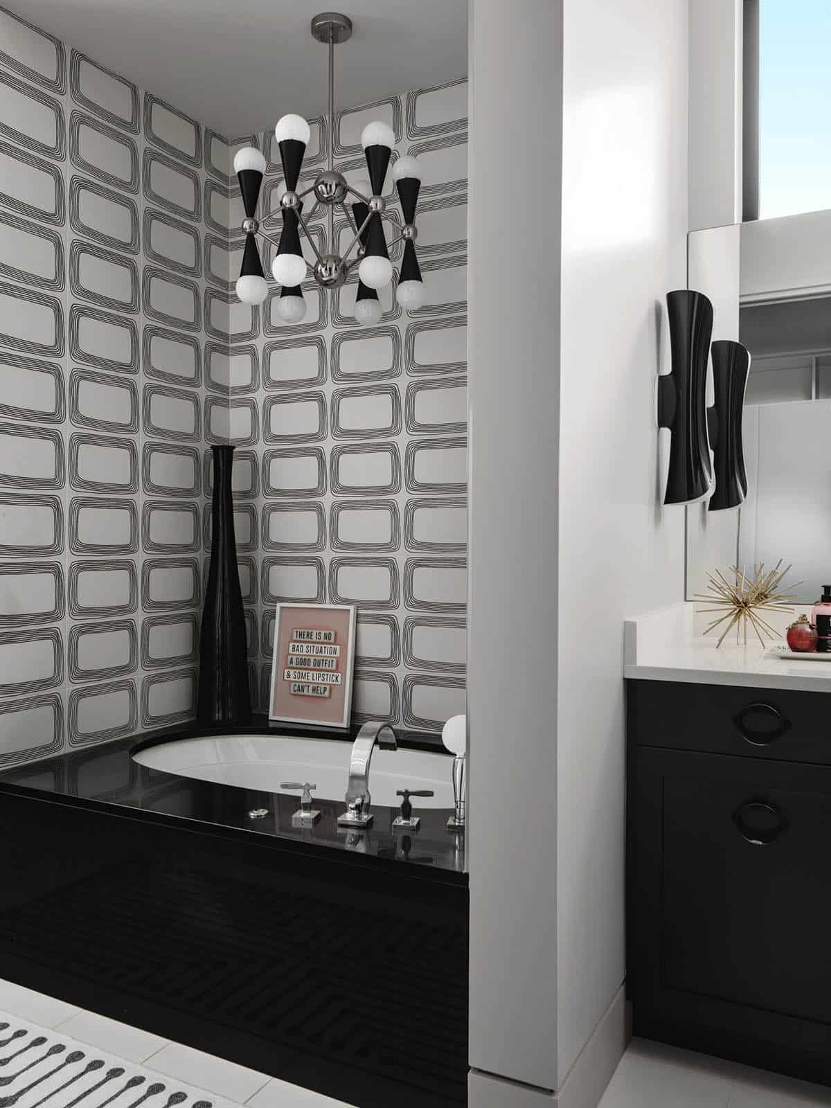 Black and white bathroom with retro chandelier and sculptural soaking tub