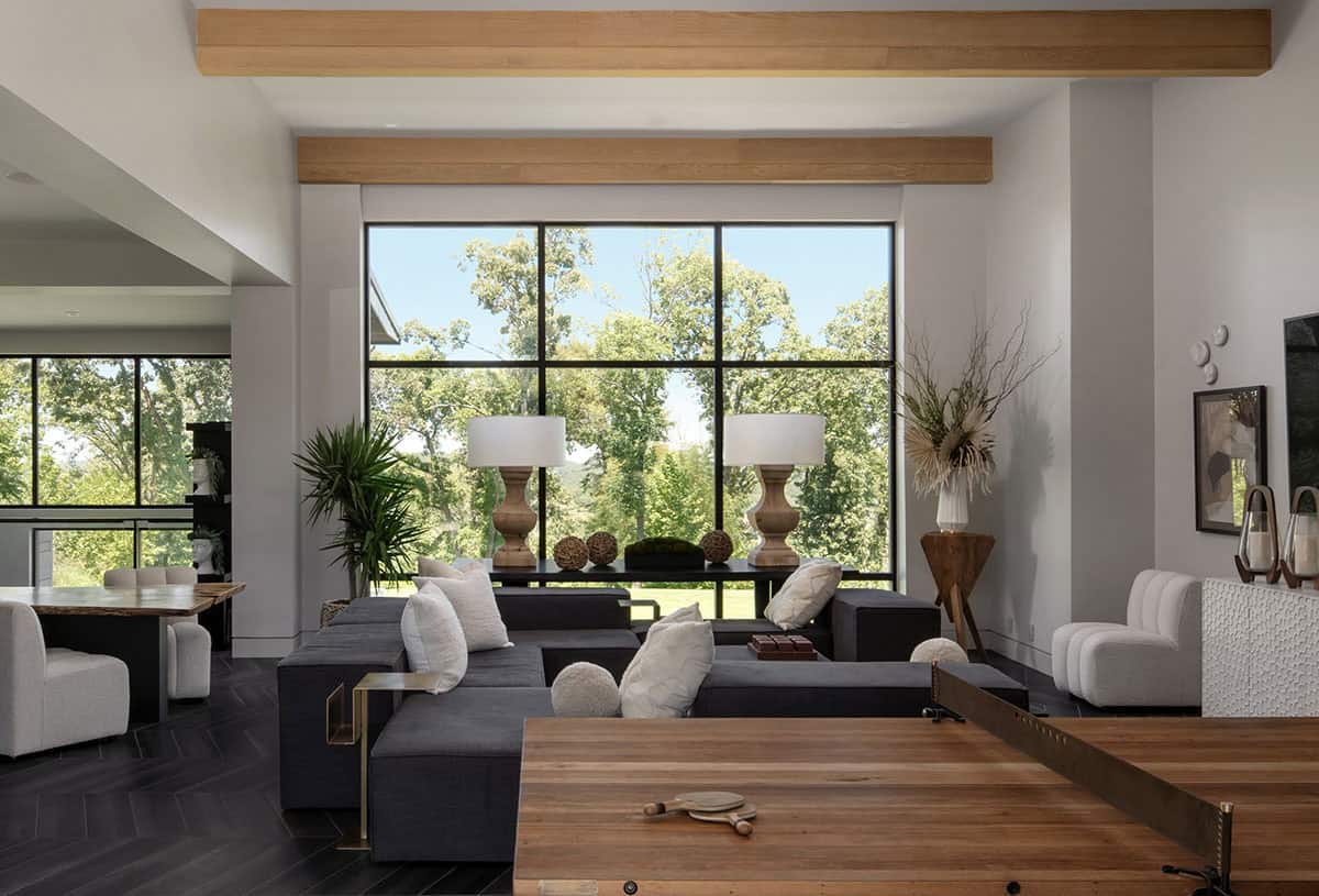 Game room with dark herringbone floors and floor-to-ceiling window views