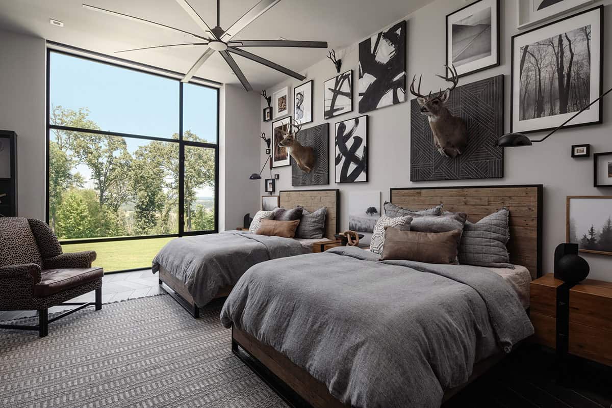 Bunk room with taxidermy deer mounts and black and white gallery wall