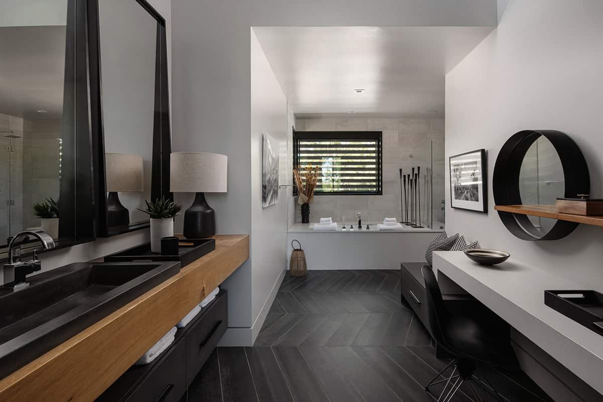 Primary bathroom with dark chevron tile and freestanding soaking tub