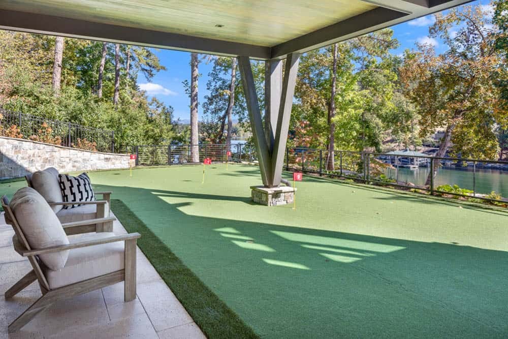 Covered putting green with lounge chair overlooking the lake