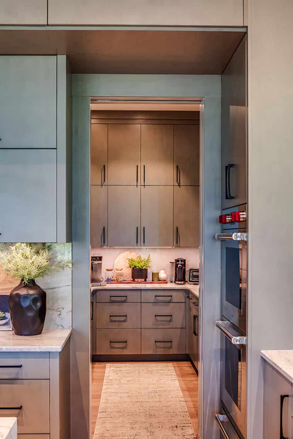 View through kitchen doorway into a butler's pantry with coffee station