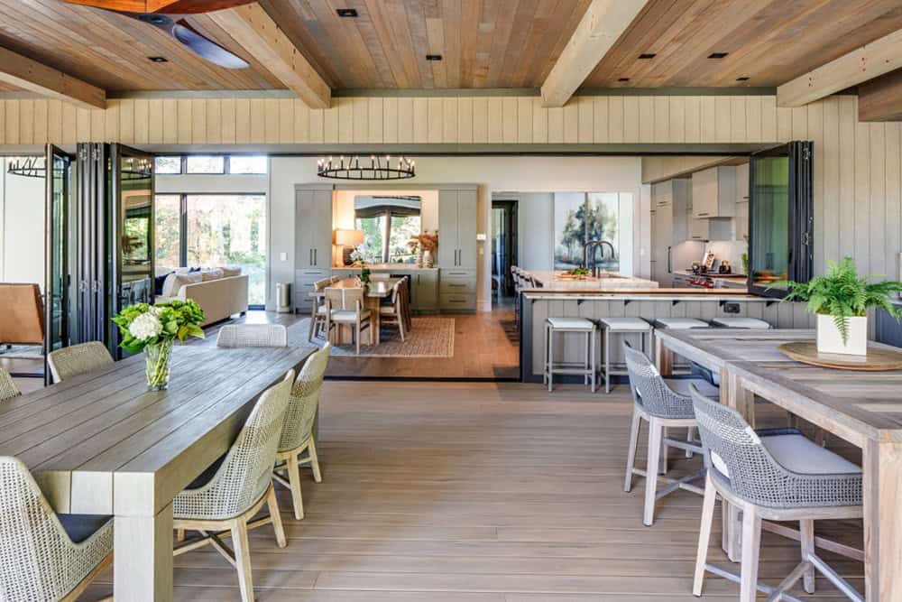 Outdoor dining deck opening into the great room and kitchen beyond