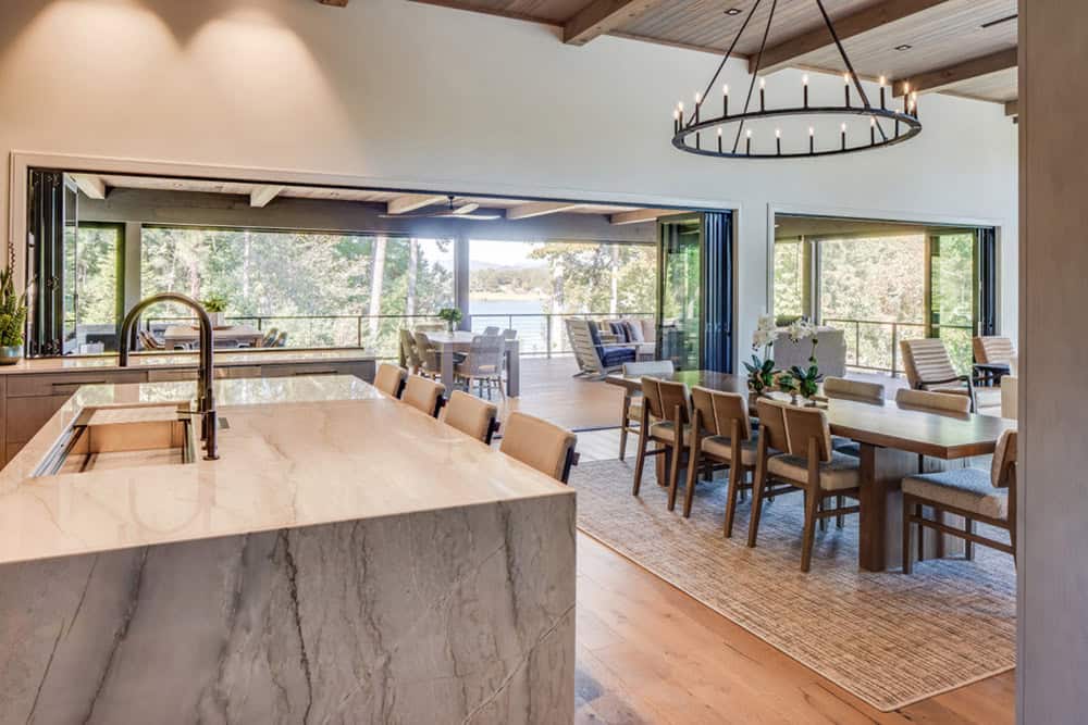 Kitchen island view toward the dining area and open deck with lake views