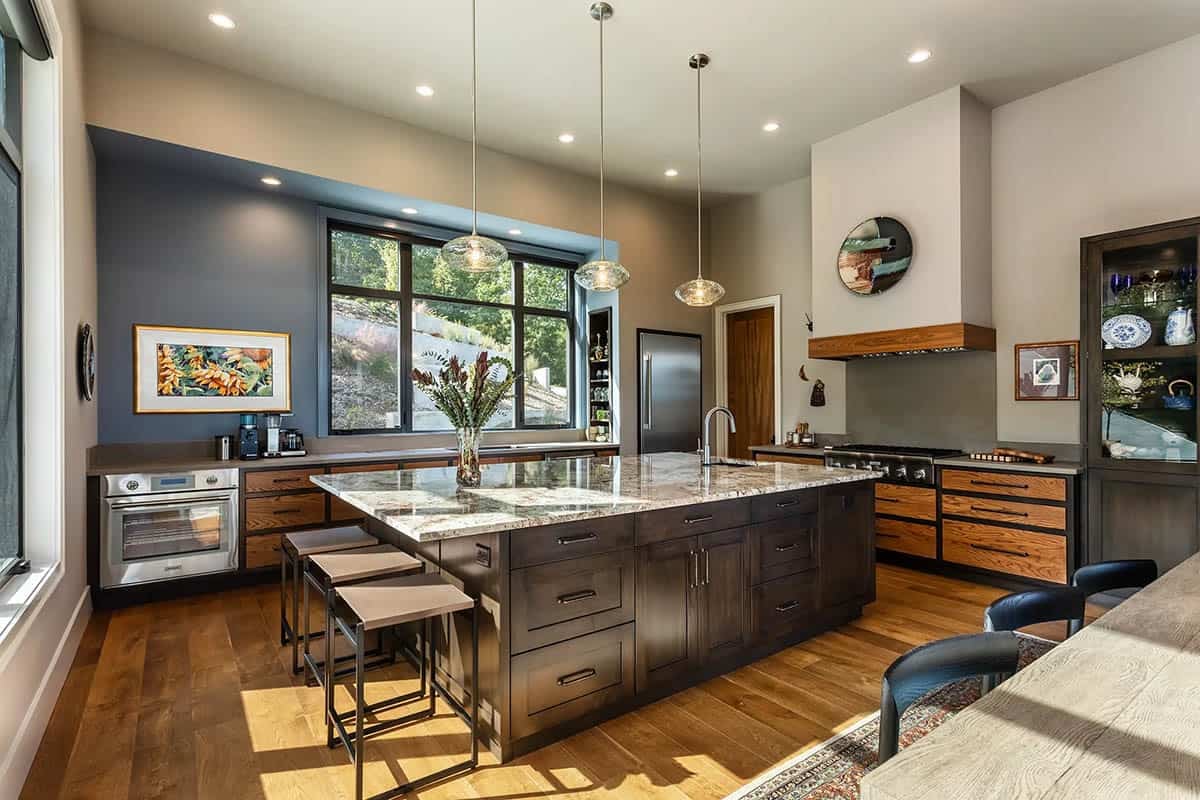 Kitchen with dark wood island, granite countertop, and pendant lighting
