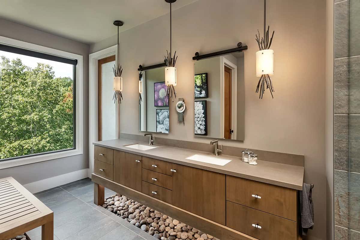 Bathroom double vanity with pendant lights and river rock accent