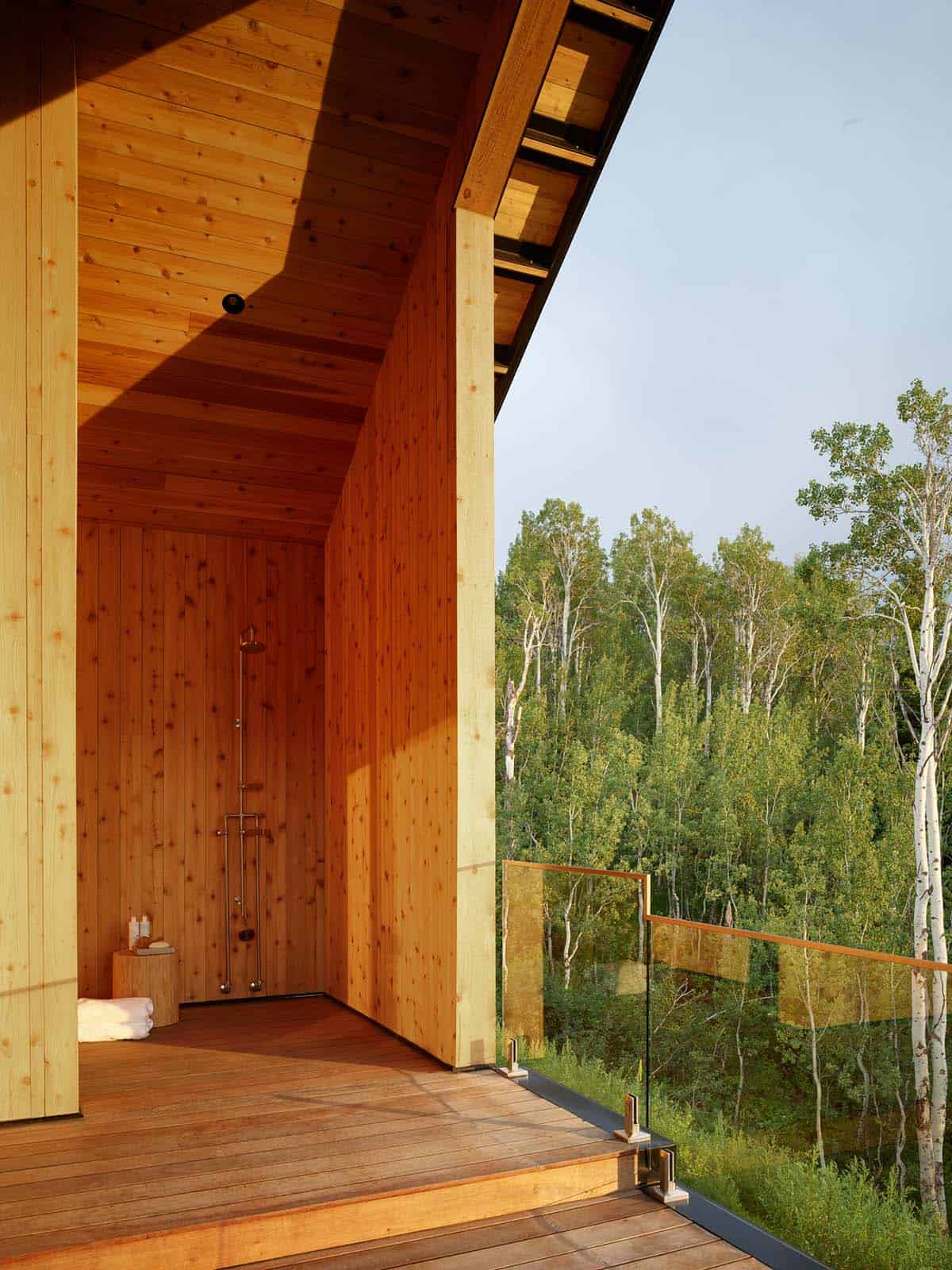 Outdoor wood shower nook overlooking aspen trees