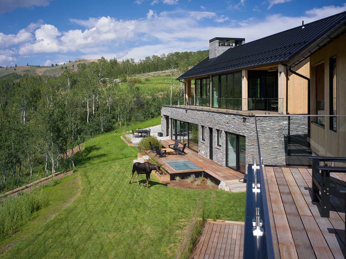 Aerial view of home exterior with moose grazing near plunge pool