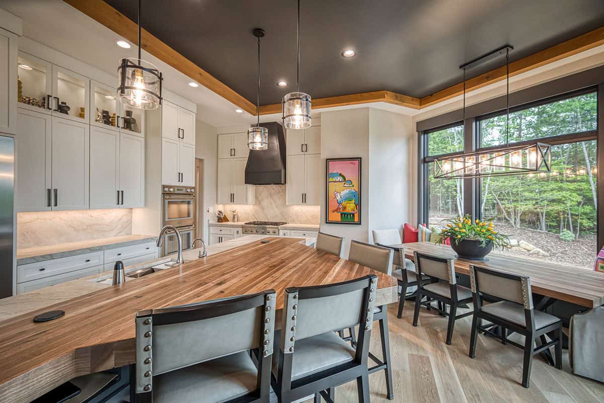 Kitchen and dining nook with pendant lighting, wood island counter, and bench seating