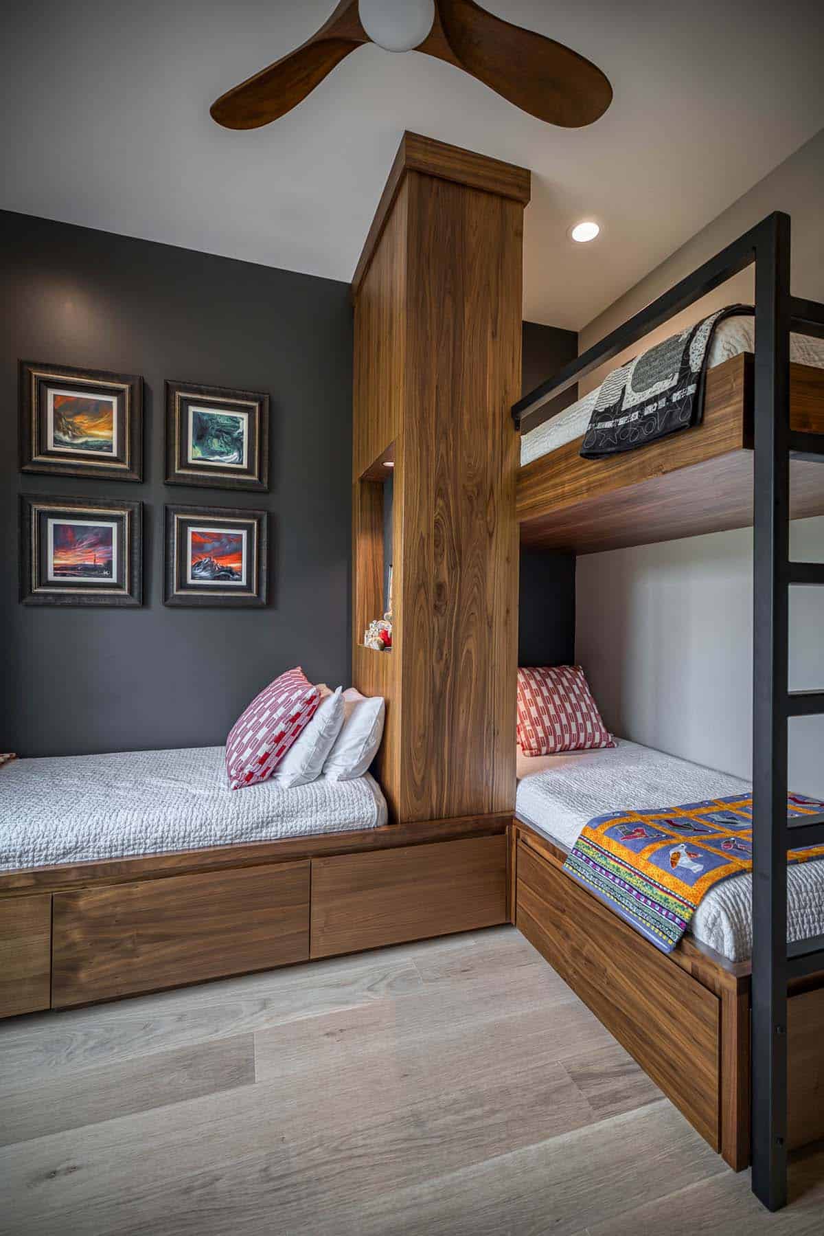 Bunk beds with wood center column, storage drawers, and colorful landscape paintings