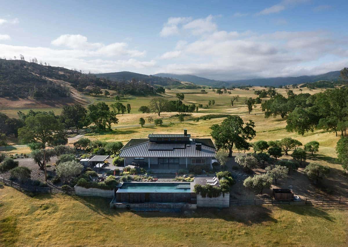 Aerial view of a contemporary ranch house nestled in rolling Pope Valley hills, with pool and surrounding pastureland