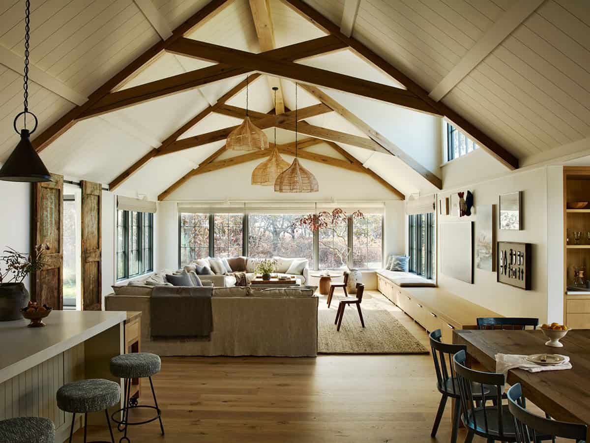 Vaulted living room with wood beams and woven pendant lights overhead