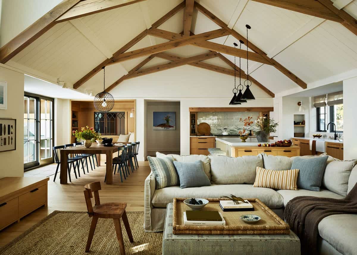 Open living and dining area beneath a vaulted wood beam ceiling