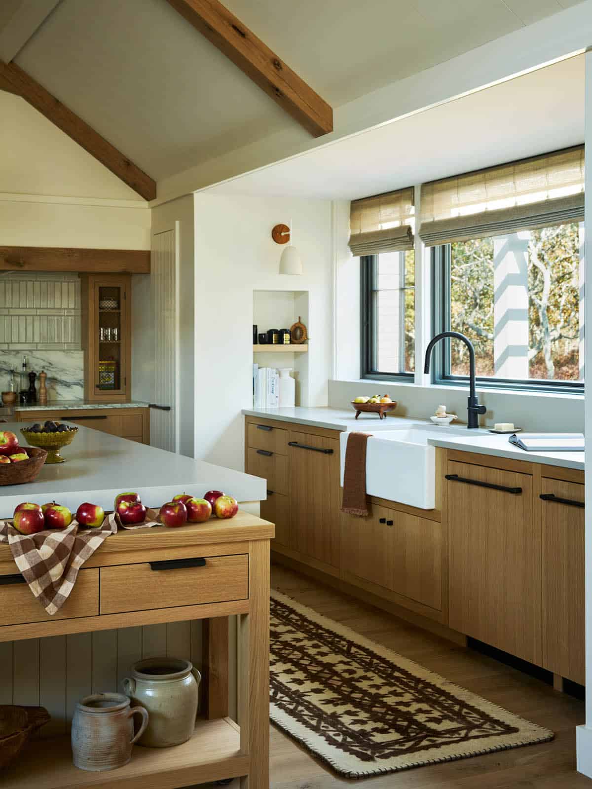 Kitchen with farmhouse sink and patterned runner beneath the window